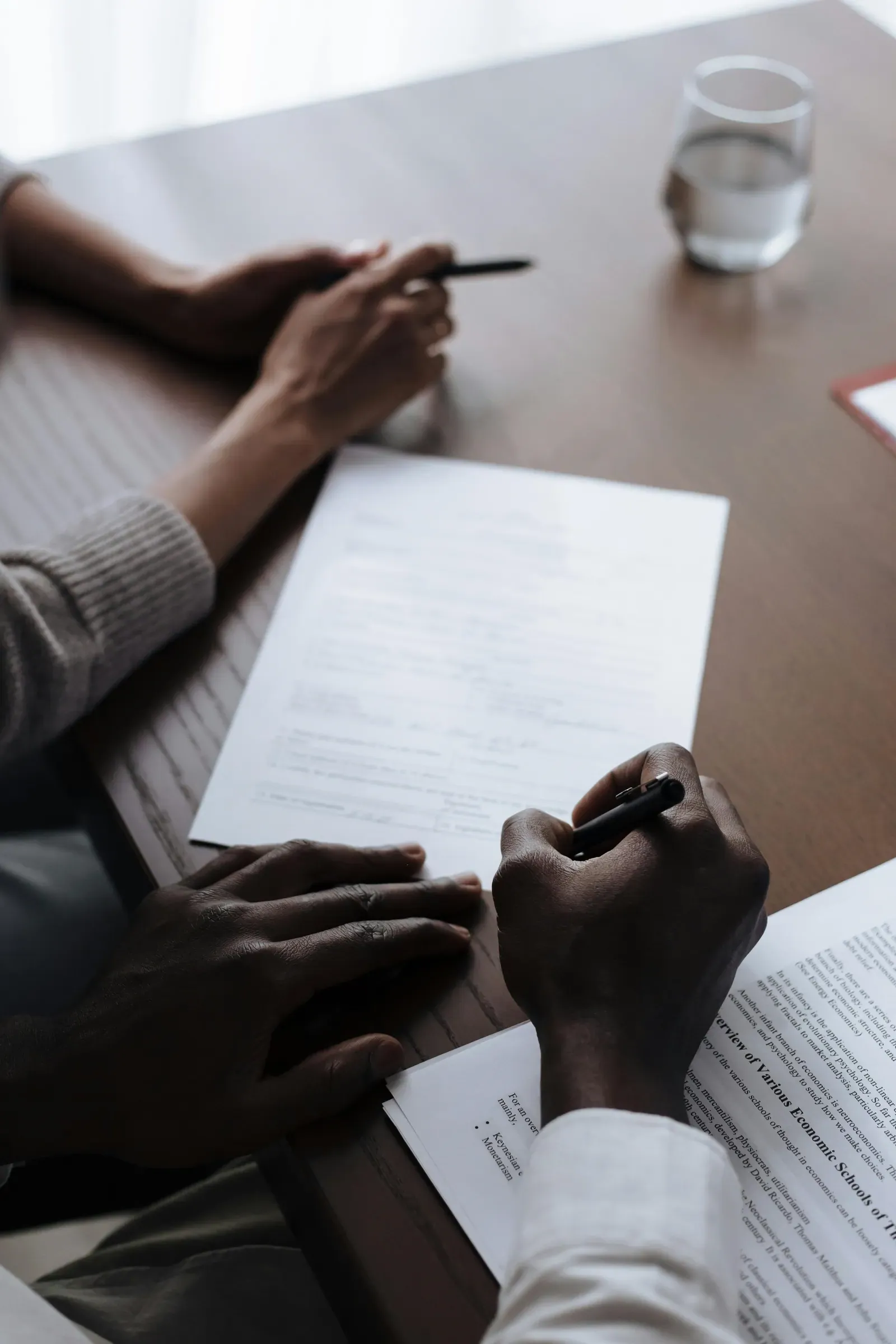 Advisory engagement at desk with financial documents